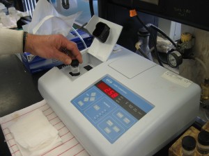 lab hand at turbidimeter
